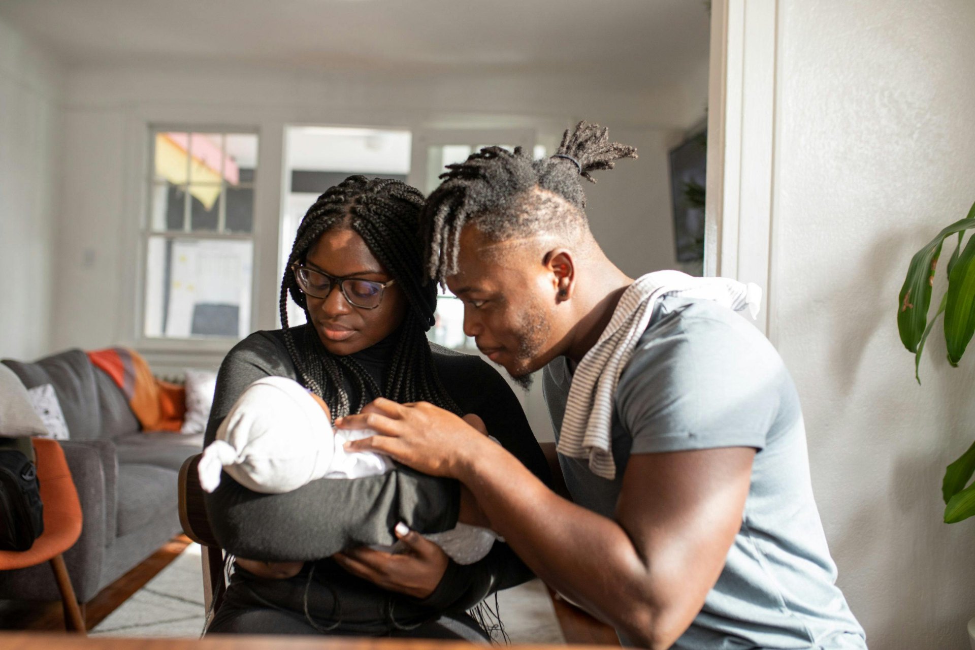 New parents with their newborn at home
